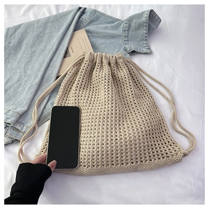 Detailed macro view of beige crochet mesh backpack texture and drawstring closure details