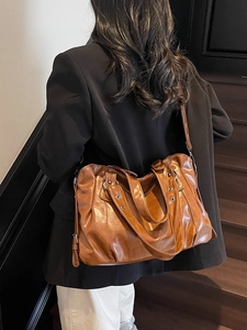 Vintage brown leather tote bag for women showing a casual crossbody commuter design