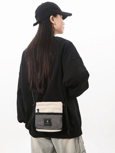 Minimalist beige functional crossbody bag with black mesh pocket and cord strap
