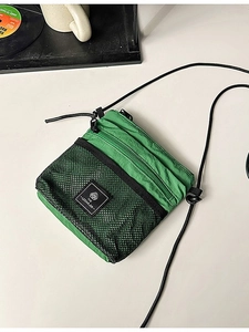 Bright green nylon functional crossbody bag with mesh pocket and adjustable shoulder strap