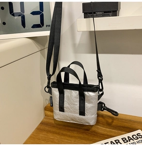 Détail du sac à bandoulière argenté métallisé avec tissu texturé et sangles noires