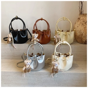 Mini bucket bags collection in five colors featuring teddy bear charms and pebble grain texture