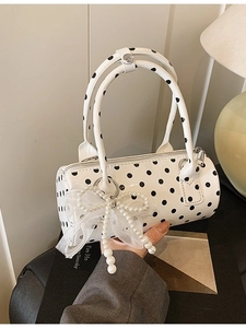 White polka dot cylinder handbag with pearl bow charm and dual top handles