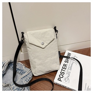 Dettaglio della mini borsa a tracolla in nylon bianco con bottone automatico e logo