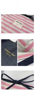 Detail of pink striped canvas with blue denim patchwork and Unleash Your Potential embroidery
