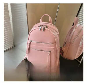 Detail view of pink lychee texture PU leather backpack with multiple zipper compartments