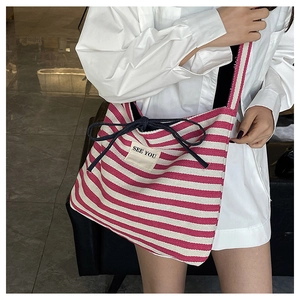 Detail of pink striped canvas tote bag with drawstring bow and See You label