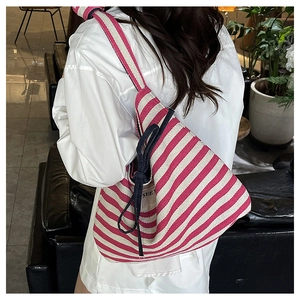 Detail of pink and white striped canvas tote bag showing the navy blue drawstring closure