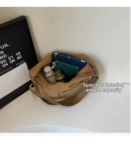 Spacious interior of a nylon tote bag holding a tablet, umbrella and cosmetics