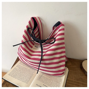 Detail of red and white striped canvas tote bag with See You patch and drawstring