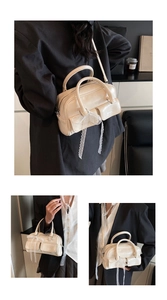 Close-up of beige oil wax leather bowling bag with lace bow and flap pockets