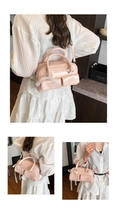 Detail of pink oil wax leather bowling bag featuring decorative lace and front pockets