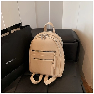 Close-up of beige lychee grain PU leather backpack with multi-zipper pocket detail