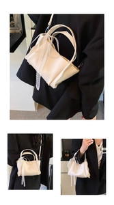 Detailed view of the lychee texture leather and lace bow on a beige bucket handbag