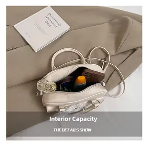 Internal capacity of beige leather crossbody bag showing makeup and mobile phone storage