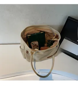 Interior view showing large capacity of canvas tote bag with tablet and daily essentials