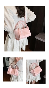 Detailed view of pink leather bucket bag with white lace handle and adjustable strap