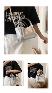 Detail of silver textured mini tote with white lace ribbon and adjustable shoulder strap