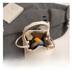 Macro view of beige lychee leather bucket bag interior showing spacious storage capacity