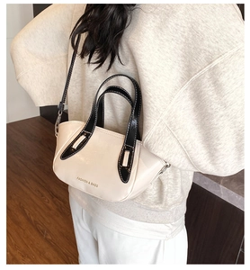 Model view of cream bucket bag with black handles and FASHION & BAGS lettering
