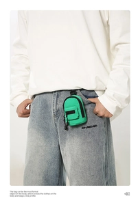Mini backpack-style waist coin purse in lime green attached to denim jeans belt loop
