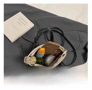 Top view of white crossbody pillow bag showing internal capacity with daily essentials