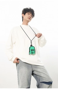 Green mini neck pouch crossbody bag shown with woven strap on a white shirt