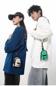 Mini canvas backpack coin purses in cream and green shown on male and female models