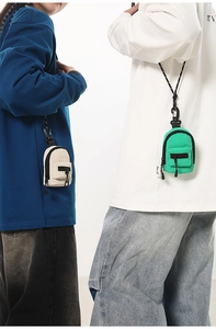 Mini canvas backpack coin purses in off-white and green with detachable neck lanyards