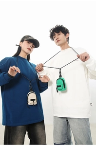 Mini backpack style neck wallets in cream and green worn by models as trendy accessories