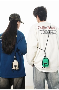 Mini backpack-style coin purses in cream and green with woven straps worn by models