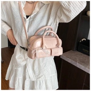 Detail of light pink mini square bag with lace bows and silver-tone hardware accents