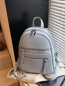 Light blue-grey lychee texture backpack with multiple pockets and silver zippers