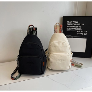 Dual-use chest bag in black and beige with jacquard straps and embroidered details