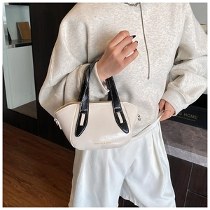 Detail of cream and black contrast handbag with FASHION & BAGS print and top handle