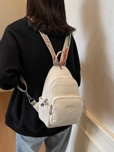 Versatile beige mini backpack for women featuring stylish colorful jacquard shoulder straps