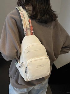 Chic white crossbody chest bag for women with floral bohemian strap worn by model