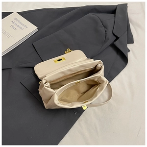 Detailed interior of beige leather crossbody bag featuring multi-compartment storage