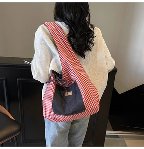 Detail of red checkered tote bag with denim pocket and adjustable drawstring