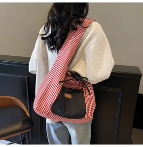 Detailed back view of a red and white checkered tote bag featuring a denim front pocket