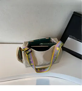 Interior view of beige nylon bowling bag showing large capacity and colorful strap