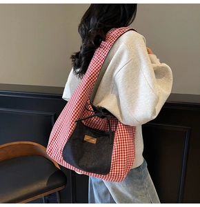Detail of red gingham tote bag featuring a denim front pocket and decorative bow knot tie