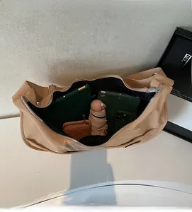 Spacious interior of a beige nylon tote bag holding a tablet, phone, and folding umbrella