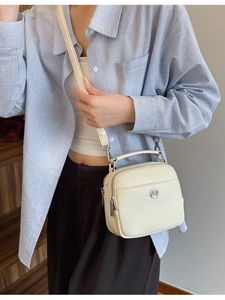 Chic beige square crossbody bag with dual zipper compartments and silver hardware
