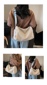 Detail view of large beige crossbody bag with patterned wide strap and side zip