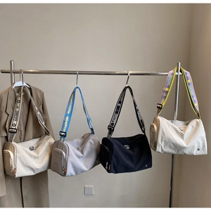 Detail showing various colors of large capacity cylinder crossbody sports bags for women