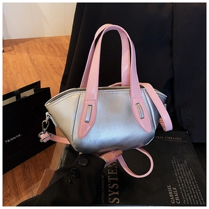 Detail of silver bucket bag with pink handles and silver hardware for women