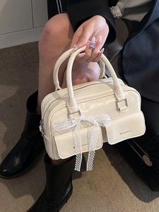 Fashionable cream PU leather handbag with lace bow detail and dual front pockets