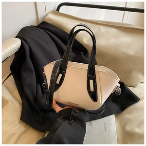 Detail of cream leather bucket bag with black handles and fashion letter print