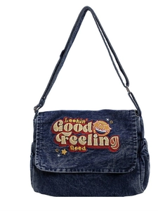 Denim shoulder bag with retro Lookin Good embroidery and adjustable strap on white base